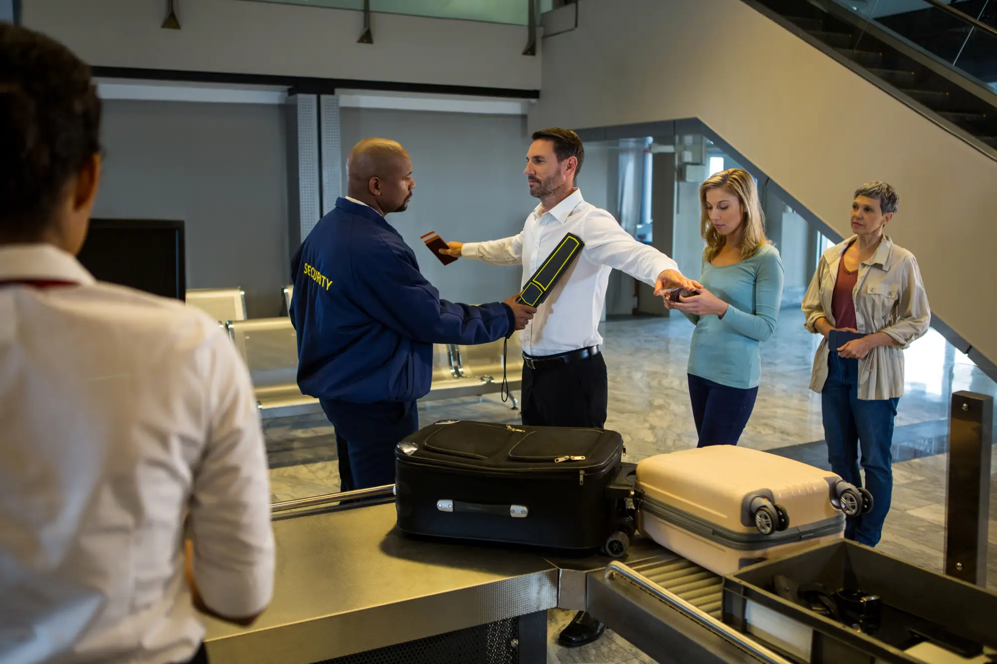 security-guard-frisk-passengers-standing-in-queue